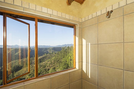 Cliffhanger Cottage shower with a spectacular view - Fully Equipped Knysna self-catering accommodation close to Knysna forest attractions. Ideal for two.